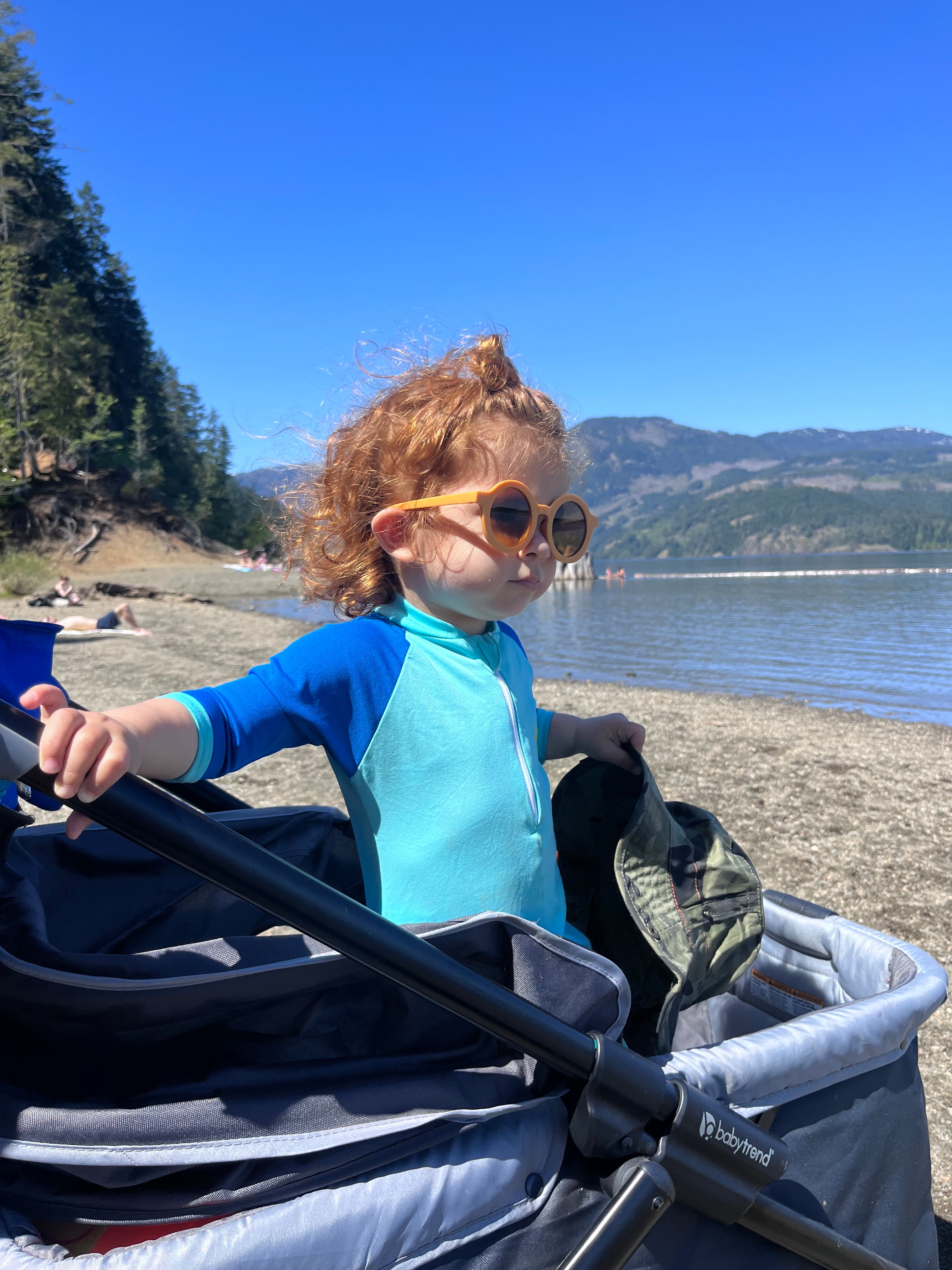 Toddler in sunglasses at the lake
